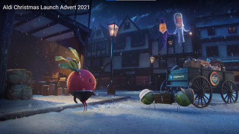 Aldi's Christmas Ad - Sprouts loading food on to a cart, while vegetable ghosts and a radish watch 