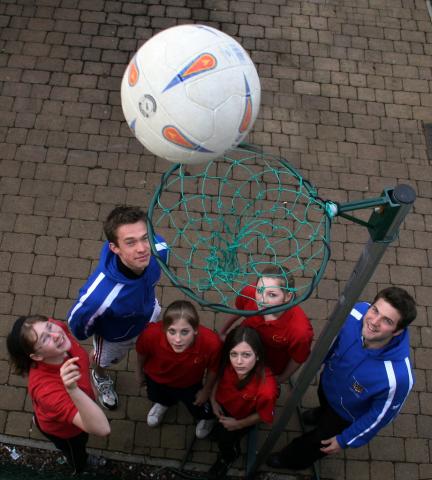 youngsters looking up at netball net