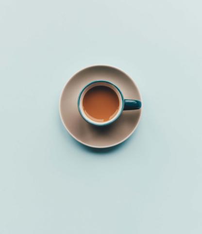 Birds eye view of English breakfast tea in a blue tea cup. Also blue background 