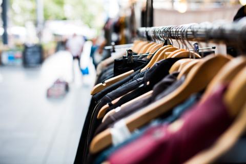Close up image of clothes on a clothing rack with background blurred