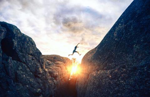 boy jumping over gap