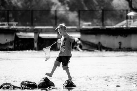 Boy playing on rocks