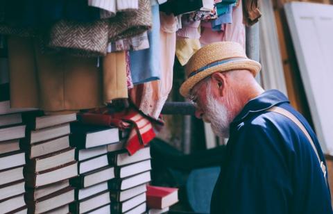 elderly man browsing books