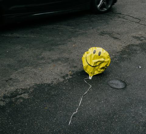 Deflated happy face balloon