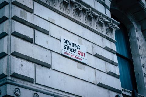 Image of downing street road sign on the side of a building