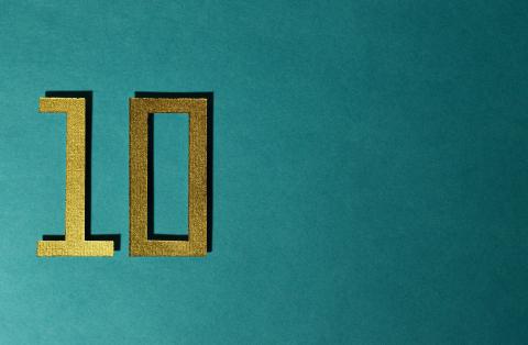 Number 10 in gold against a turquoise blue background