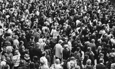 a black and white image of a dense crowd of people