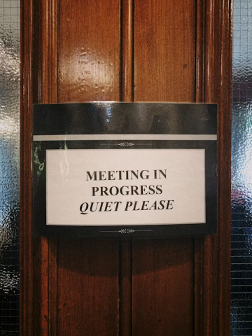 Meeting in progress sign