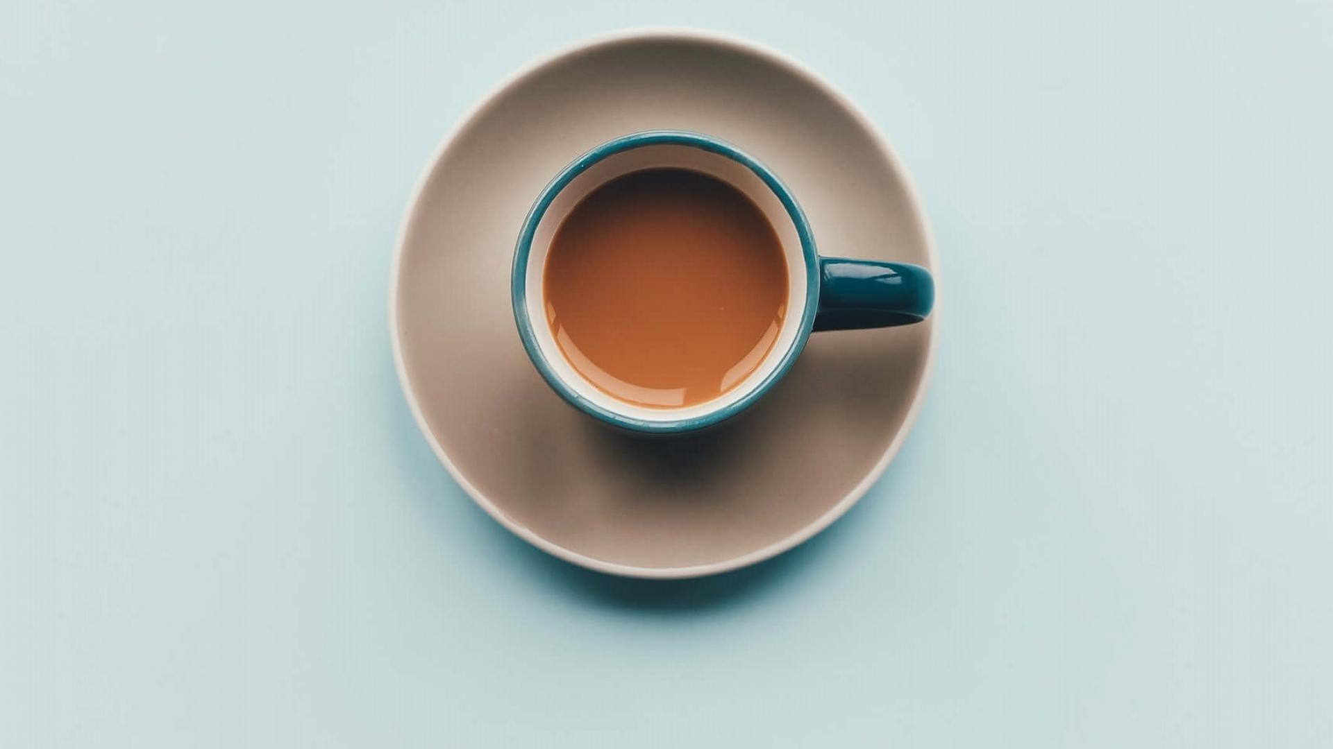Birds eye view of English breakfast tea in a blue tea cup. Also blue background 