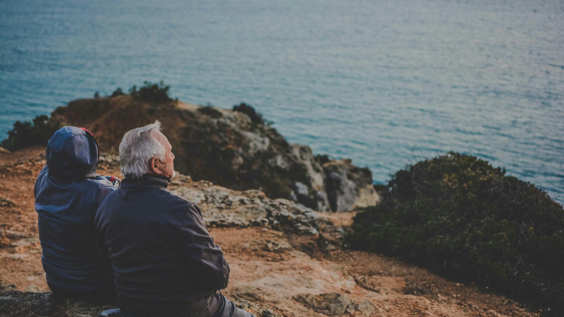 Old couple sitting by the sea