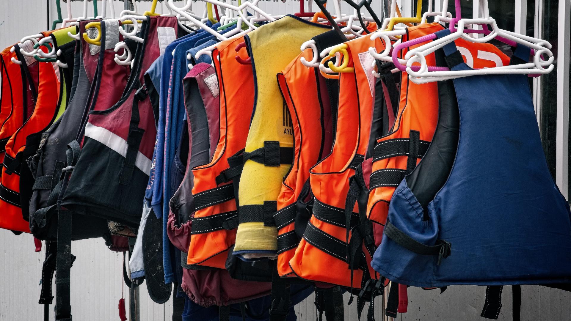 Life jackets hanging on rail