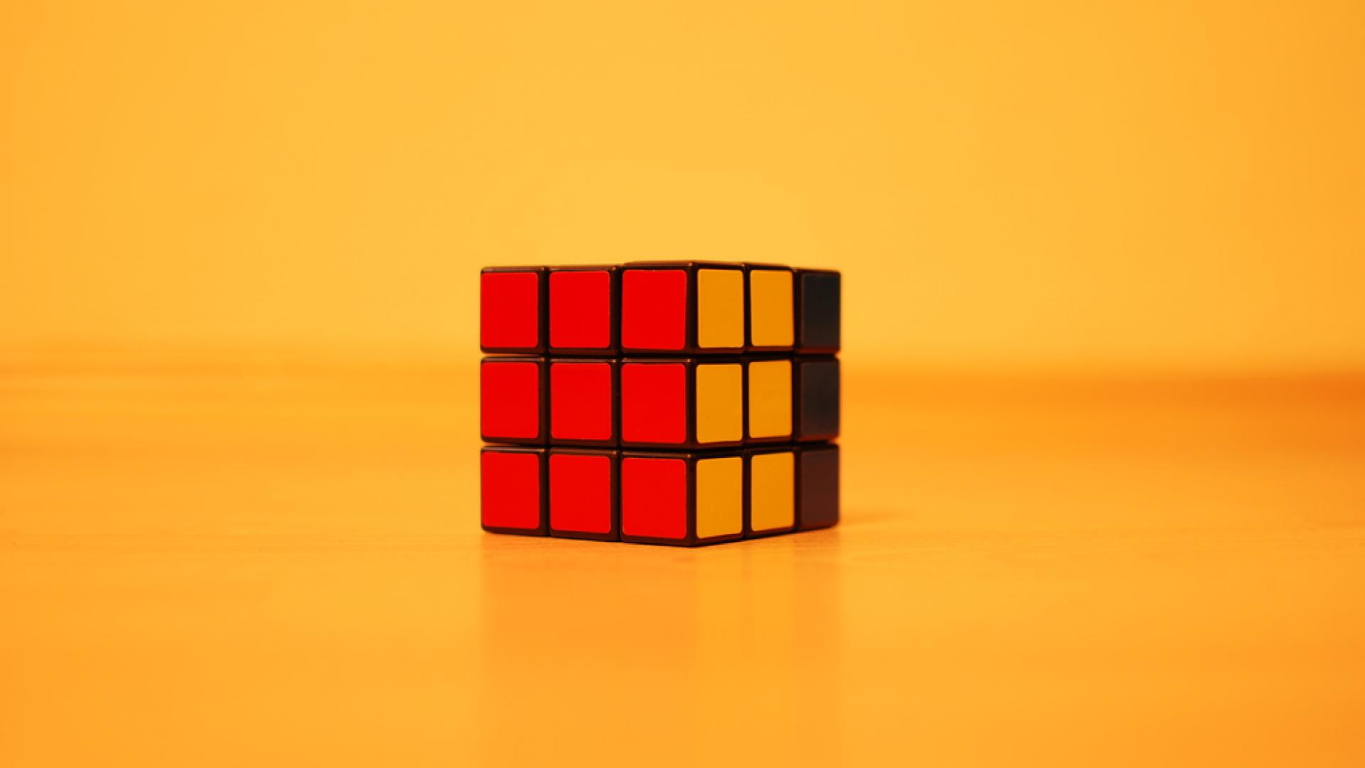Image of rubik's cube against a yellow background